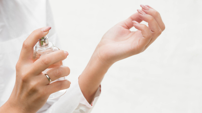 person applying perfume