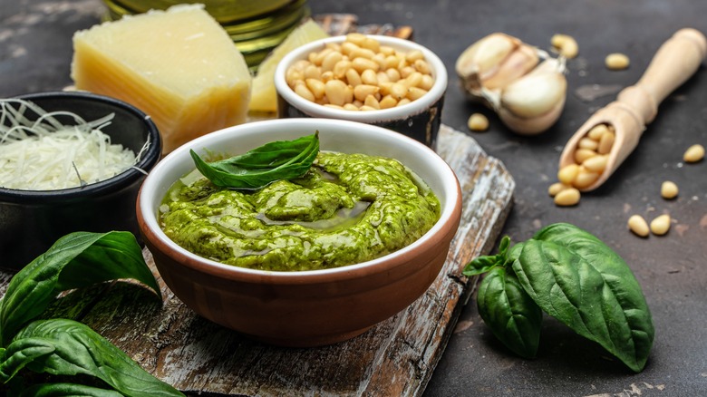 Bowl of pesto with surrounding ingredients