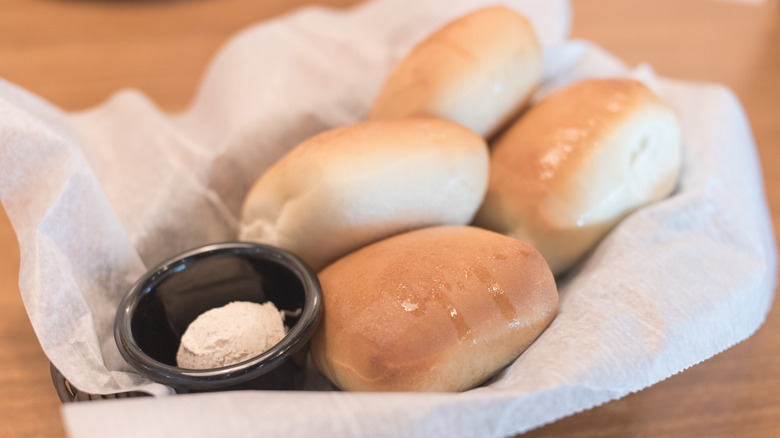 Texas Roadhouse rolls in a basket with butter