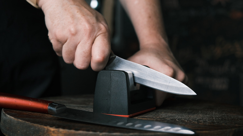 Person sharpening a knife 