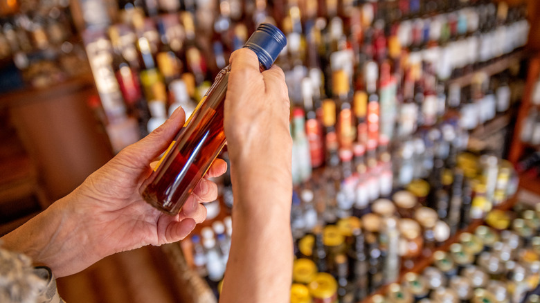 customer holding bottle in liquor shop