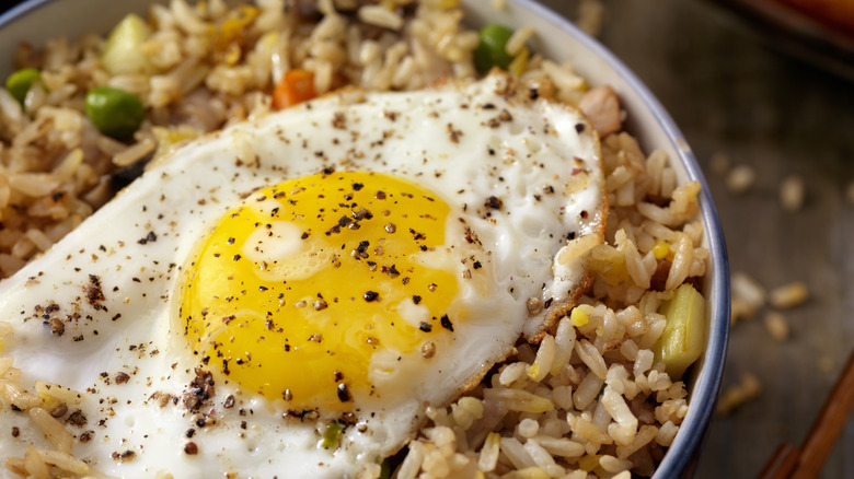 a fried egg on top of rice