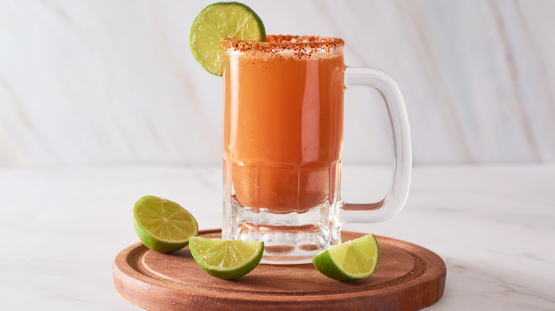 Michelada with lime wedges.