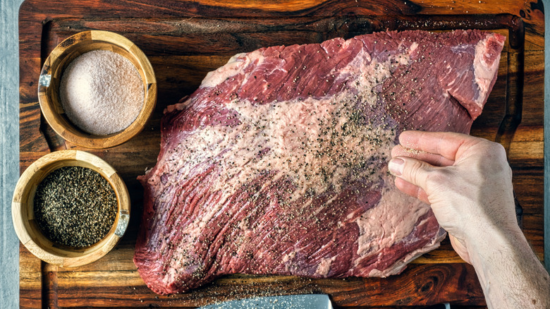 Hand salting brisket