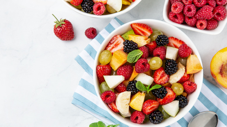 bowls of fruits salad with napkins