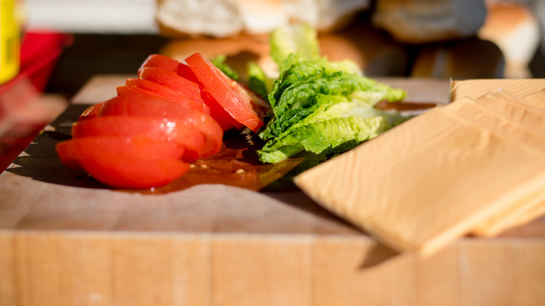 Burger toppings on cutting board