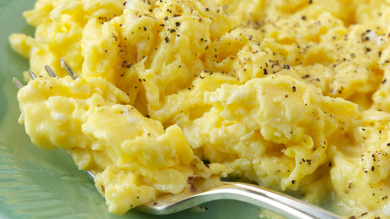 Scrambled eggs served with salt and pepper