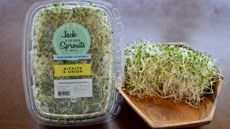 Alfalfa sprouts in a package and in a wooden bowl