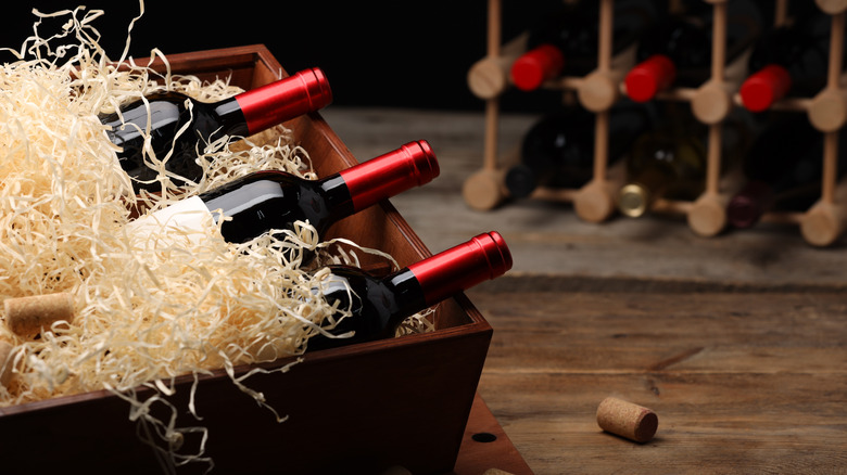 wine bottles stored in boxes and shelves