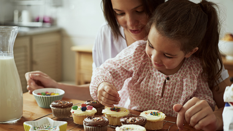 girls decorating cupcakes