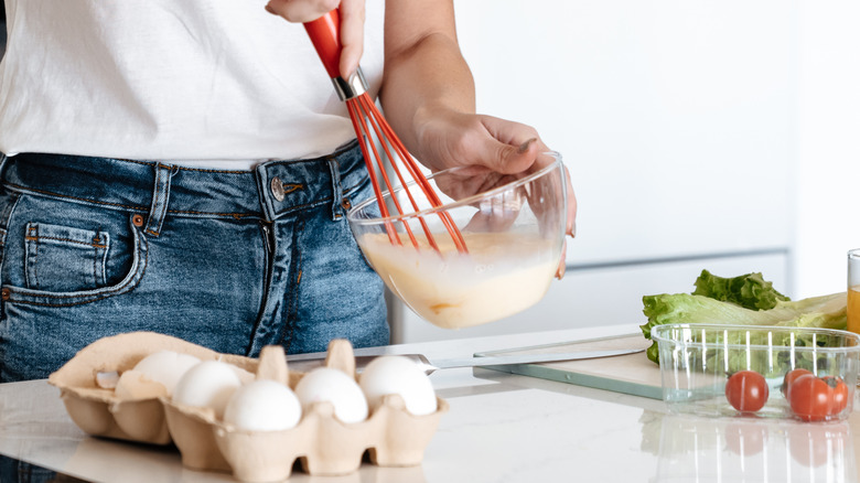 whisking scrambled eggs