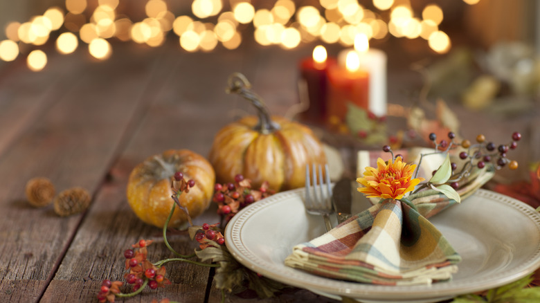 Thanksgiving place setting with pumpkins.