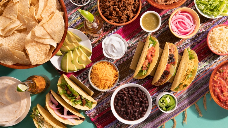 taco toppings on crowded table