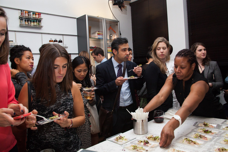 Guests Sample a Signature Singapore Cocktail and Small Bites 