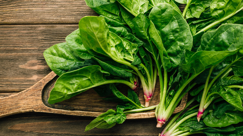 Spinach leaves on wooden backgrounds