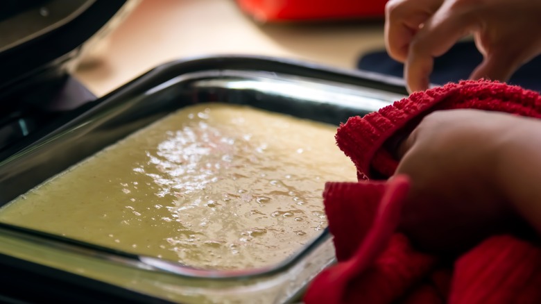 Person holding baking dish with batter