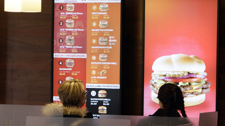 People examining Wendy's menu