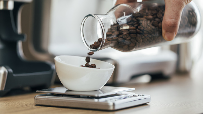 Pouring coffee beans onto scale