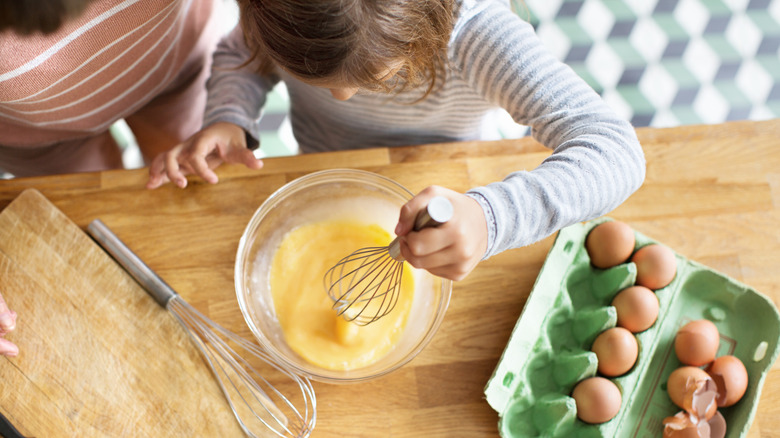 girl making scrambled eggs