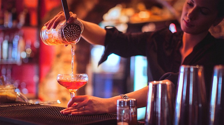 Bartender pouring drink from mixer 