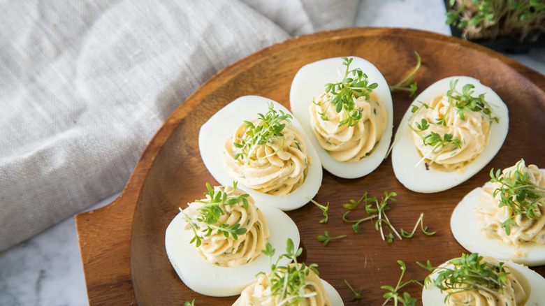 Deviled eggs on wooden plate