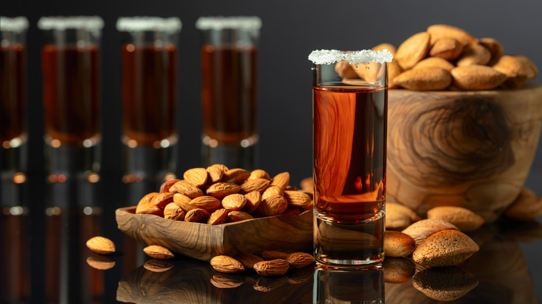 Glass of amaretto beside almonds