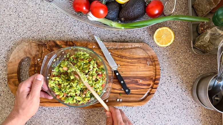 Person making guacamole