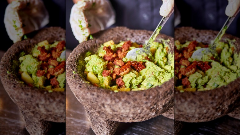 Person making BLT guacamole