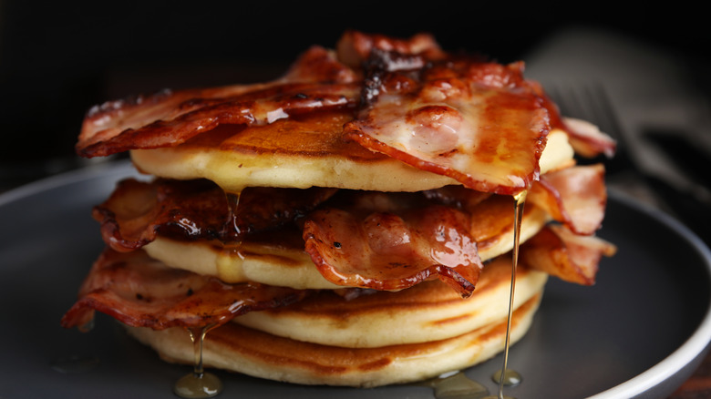 bacon strips on pancakes with dripping syrup