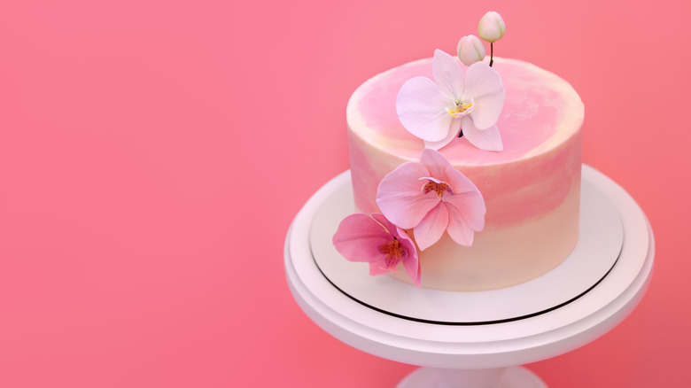 Pink cake topped with flowers