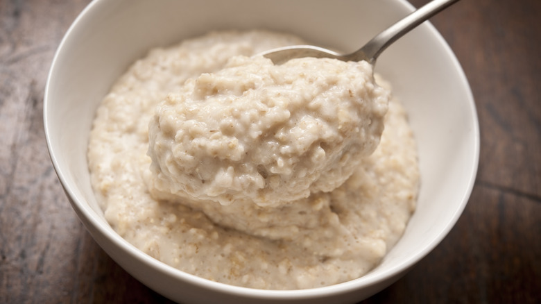 spoon scooping creamy oatmeal bowl
