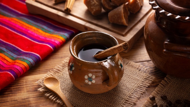 Mug of caffe de olla on festive background