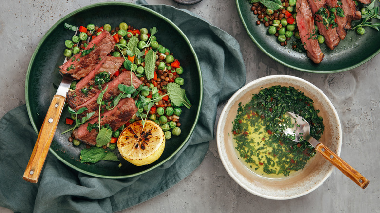 Sliced steak drizzled with chimichurri sauce