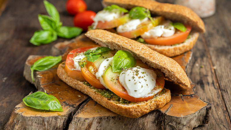 Pesto tomato sandwiches with fresh mozzarella and basil.