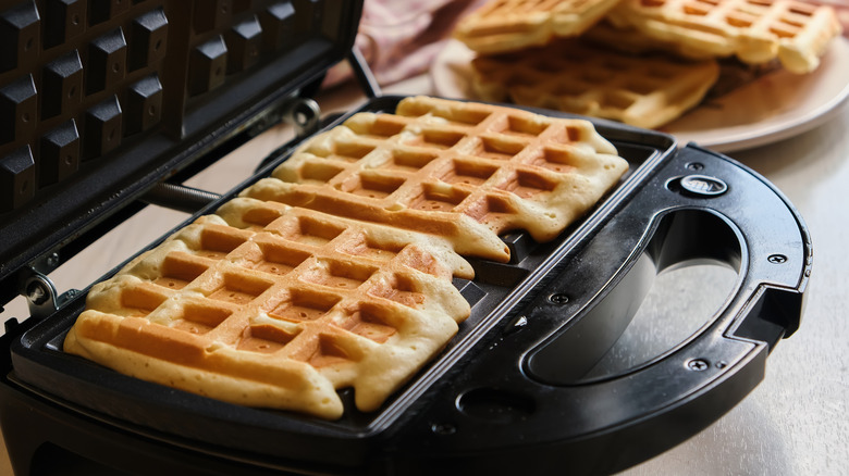 cooking waffles on waffle iron