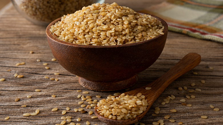 wooden bowl of white sesame seeds