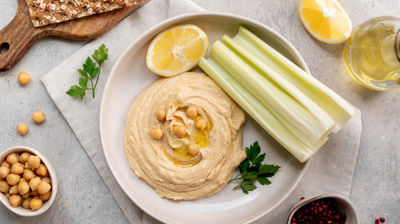 Hummus and celery on plate