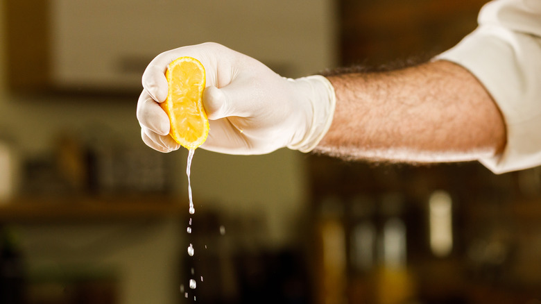 lemon slice being squeezed