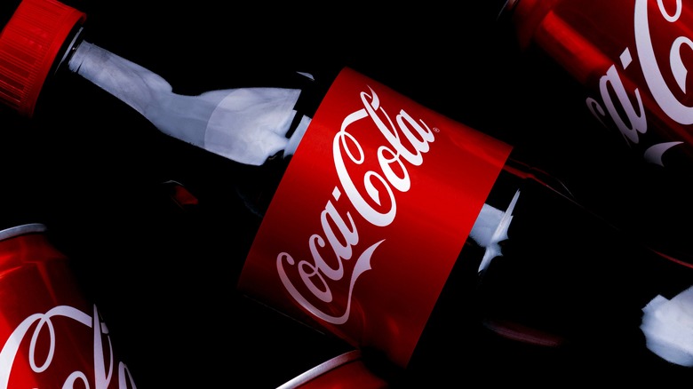 Coca-Cola bottle and cans