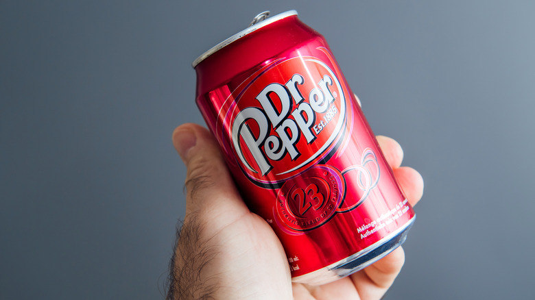 Person holding Dr Pepper