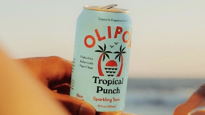 Person holding tropical punch soda