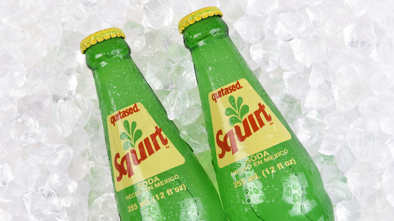 Squirt soda bottles on ice