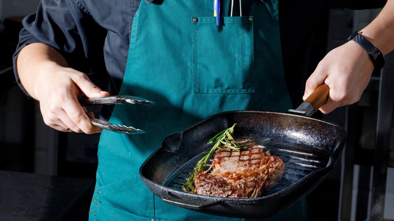 Chef cooking dry-aged steak