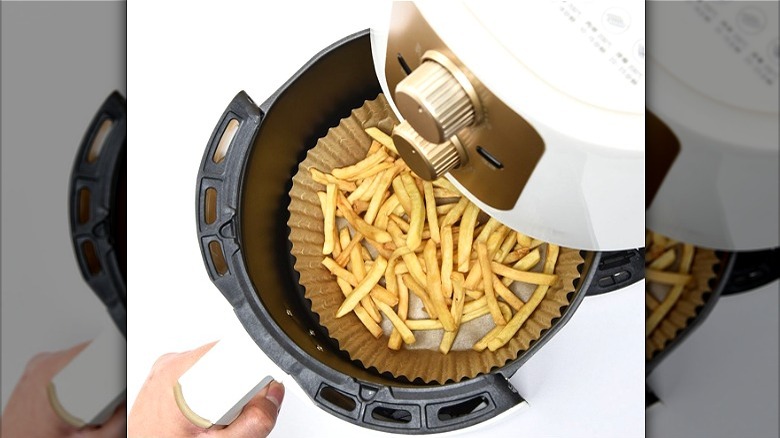 Lined air fryer with French fries 