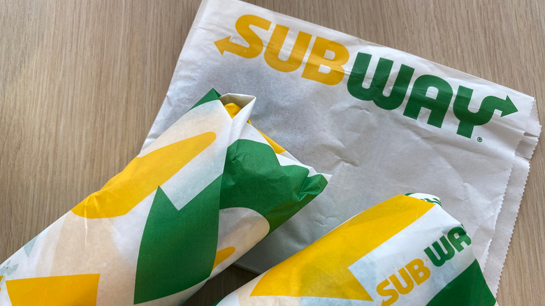 A Subway napkin and two sandwiches