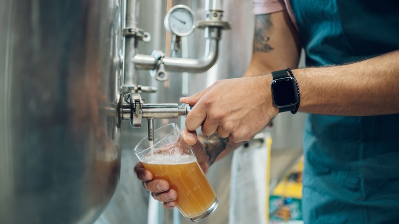 Craft beer pouring from tank