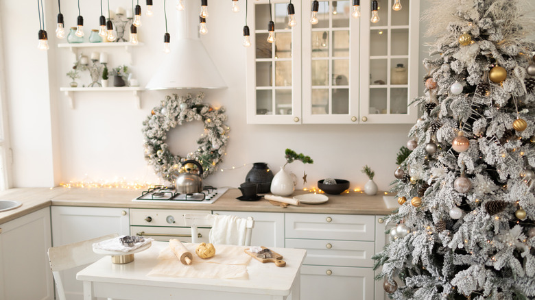 kitchen decorated for christmas with a white tree