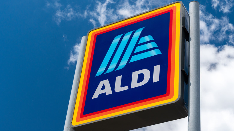 Aldi sign against cloudy sky