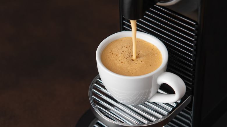  Coffee machine pours coffee into mug