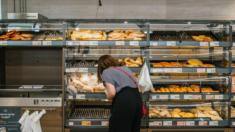 Woman selecting bread from Aldi